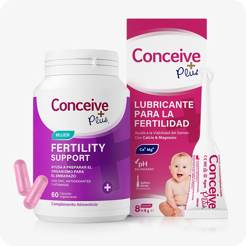 Conceive Plus Women's Fertility Support + Applicators (ES) bundle featuring a white bottle with a magenta and purple label, two light pink capsules, a white and pink lubricant applicators box, and a white single-use applicator, all displaying Spanish text for product details and usage.