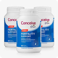 Conceive Plus Men's Fertility Support + Fertility Lubricant (ES) showing 3 pack of Fertility Support Hombre bottles, each labeled with the red “Hombre” tag and 60-capsule count, arranged in a triangular layout on a white background.