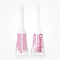 Conceive Plus Women's Fertility Support + Applicators (ES) showing two white prefilled applicators upright, front and back views, with pink Spanish text displaying dosage, branding, and product details.